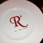 Plate with the Resturants signature logo in the center of it. 
