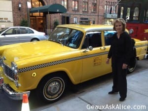 Alice standing next to a taxi in New York City