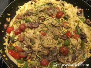 Loaded Fettuccine with Veggies and Pesto Sauce in a Skillet