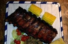 Ribs plated up with Rice dressing salad and garlic bread