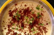 Creamy Potato Soup With Fresh Green Onions And Paprika Sprinkled On Top.