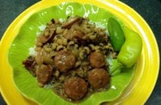 Platted up serving of Blackeyed peas with sausage over rice.