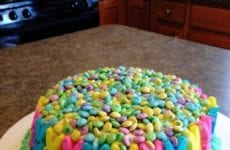 Easter Cake With M&ms On Top And Peep Bunnies All Around Sides.