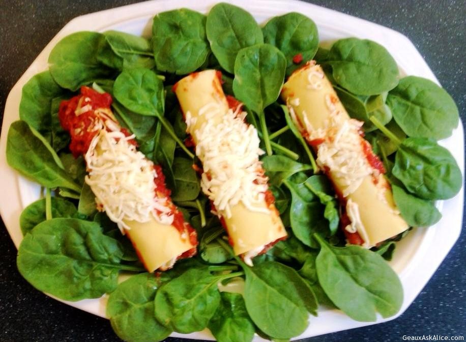 Plate of Alice's Spinach Manicotti on a bed of greens