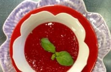 Bowl Of Fresh Raspberry Sauce With Mint Garnish