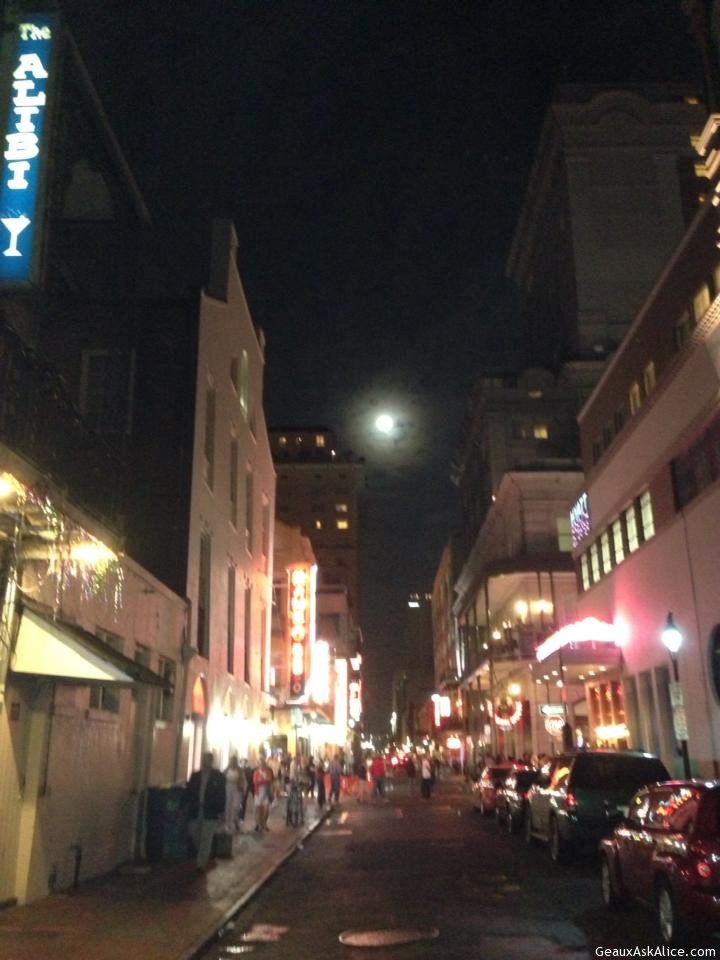 Photo looking down the street at night of New Orleans