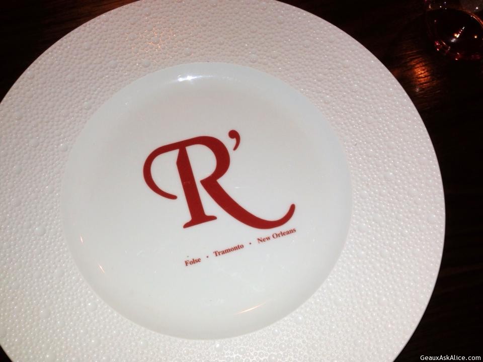 Plate with the Resturants signature logo in the center of it.