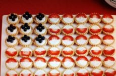 mini pies with strawberries and blueberries to look like a flag.