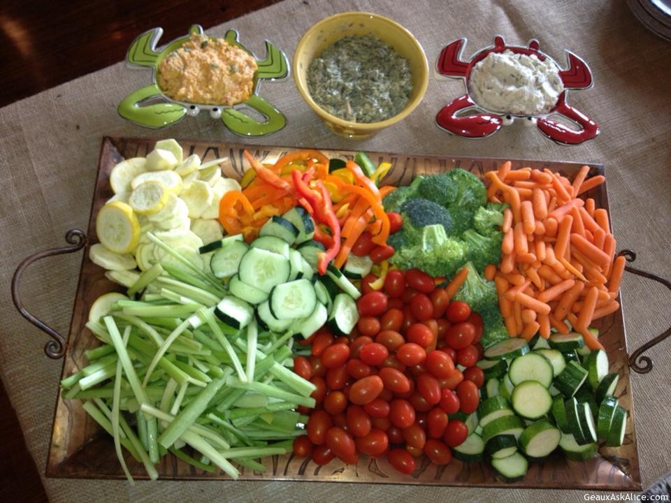 Tray of veggies cut up with three dips
