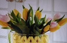 Vase lined with peep bunnies with a flower arrangement.