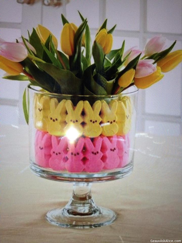 Vase lined with peep bunnies with a flower arrangement.