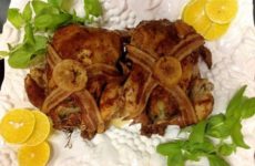 1. Wash and pat dry 2 fryers. In a bowl, mix the mustard, honey, steak sauce and garlic. 2. With your hands lift the skin away from the fryer on both breast side and under side. 3. Season the whole bird, inside and outside and under skin with salt, red/black pepper and garlic powder. 4. Take the mustard mixture and rub all over and under skin also. 5. Take the lemon slices and slide under the skin on bottom and top. 6. Take ½ of the onion, the sprig of rosemary and wrap the bacon around it and stuff in the cavity of each fryer. 7. I cooked this on my Crock Pot BBQ Grill but if you do not have one just use a nice roasting pan. 8. Place the fryers in breasts side up and place 2 slices of bacon on each in the “X” shape. 9. Pour the wine in the bottom of pan. Cover with foil. 10. Bake in oven at 400 for 45 minutes, depending on size of fryers. Remove foil and turn heat up to 425 and let brown. The wine will cook out so be careful not to burn the bottom. You can always add chicken broth instead. 11. Remove from oven and let set for 10 minutes before carving.