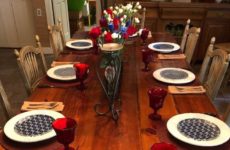 Table set with red, white and blue centerpiece and place settings.