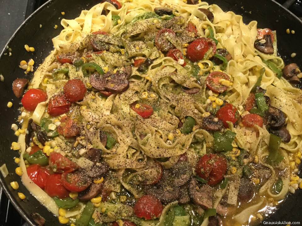 Loaded Fettuccine with Veggies and Pesto Sauce in a Skillet