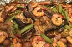 Packet of Red Snapper on Shell Nestled with Veggies, Potatoes and Shrimp