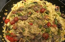 Loaded Fettuccine with Veggies and Pesto Sauce in a Skillet